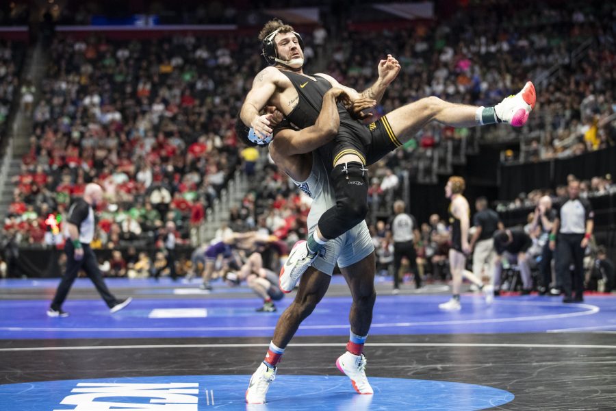 North Carolina States No. 18 Ryan Jack takes down down Iowas No. 2 Jaydin Eierman during session two at the NCAA Wrestling Championships at Little Caesars Arena in Detroit, Mich., on Thursday, March 17, 2022. Jack defeated Eierman in a 141-pound match by sudden victory, 4-2.