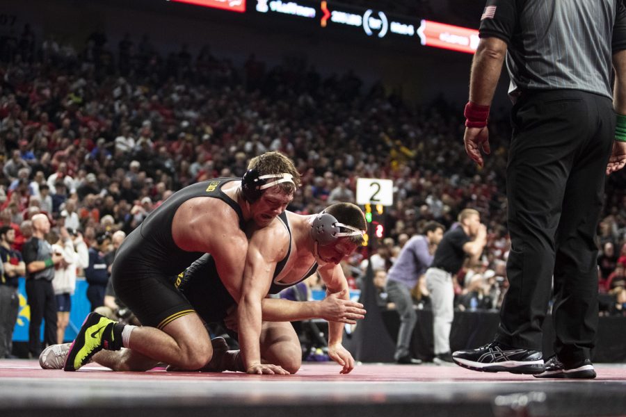 Iowa’s No. 4 Jacob Warner drives down Ohio State’s No. 9 Gavin Hoffman during session three of the Big Ten Wrestling Championships at Pinnacle Bank Arena in Lincoln, Neb., on Saturday, March 5, 2022.Warner defeated Hoffman in a 197-pound match, 4-2.