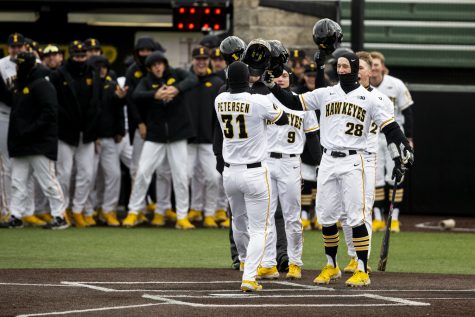 Iowa left fielder Sam Petersen celebrates a home run during a baseball game between Iowa and Central Michigan at Duane Banks Field in Iowa City on Friday, March 25, 2022. Petersen drove in three runs. The Hawkeyes defeated the Chippewas, 7-4.