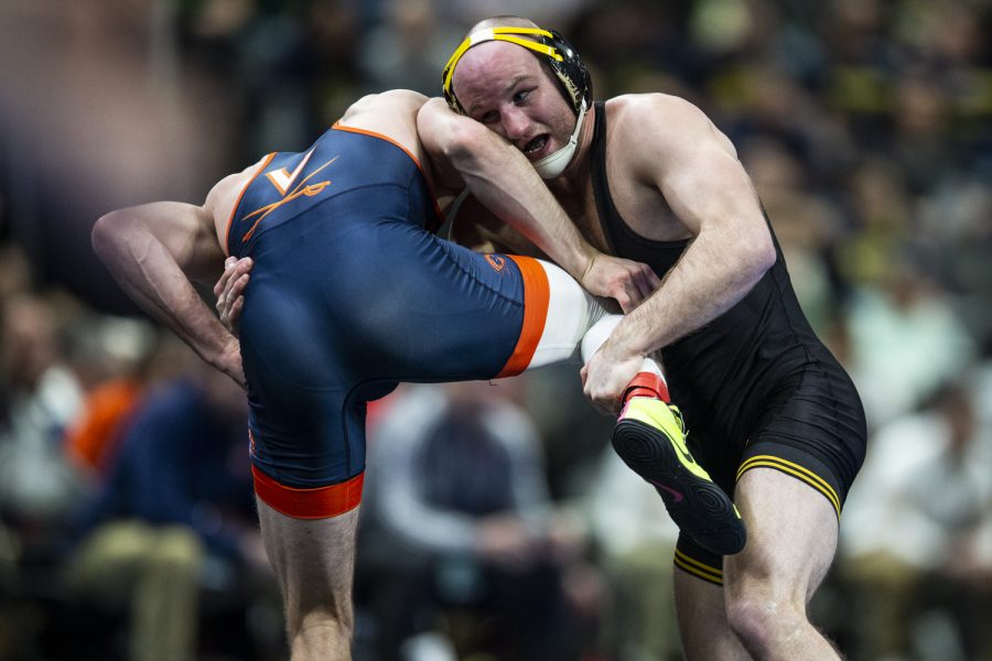 Iowas No. 3 Alex Marinelli throws down Virginias No. 19 Justin McCoy  during session two at the NCAA Wrestling Championships at Little Caesars Arena in Detroit, Mich., on Thursday, March 17, 2022. Marinelli defeated McCoy in a 165-pound match, 8-2.