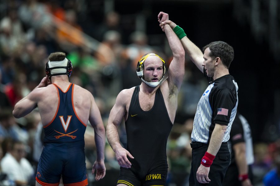 Iowas No. 3 Alex Marinelli celebrates a win over Virginias No. 19 Justin McCoy  during session two at the NCAA Wrestling Championships at Little Caesars Arena in Detroit, Mich., on Thursday, March 17, 2022. Marinelli defeated McCoy in a 165-pound match, 8-2.