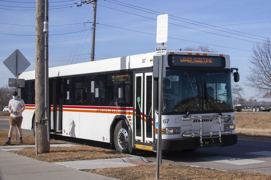 Passengers exit from the Iowa City bus to the bus stop at The Quarters apartment complex in Iowa City on Wednesday, March 2, 2022.