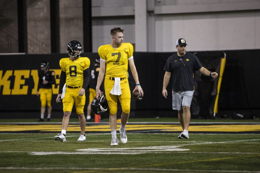 Iowa quarterbacks Spencer Petras and Alex Padilla walk onto the field during an Iowa football open practice at the Hansen Football Performance Center in Iowa City on Tuesday, March 29, 2022. Petras and Padilla both started for the Hawkeyes in the 2021-22 season.