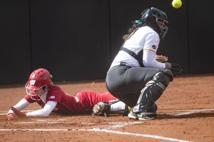 Wisconsin infielder Peyton Bannon slides into home plate during a softball game between Iowa and Wisconsin at Bob Pearl Field in Iowa City on Friday, March 25, 2022. Bannon scored two runs. The Badgers defeated the Hawkeyes, 10-5.