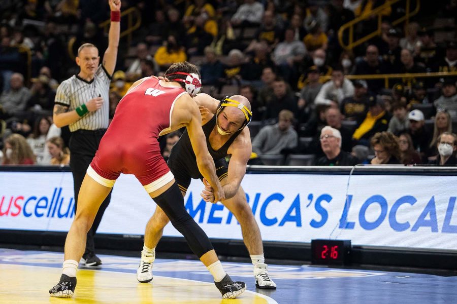 Iowa’s No. 5 165-pound Alex Marinelli battles Wisconsins No. 6 Dean Hamiti during a wrestling meet between No. 2 Iowa and No. 9 Wisconsin in Carver-Hawkeye Arena on Saturday, Feb. 5, 2022. Marinelli defeated Hamiti by decision, 8-5. The Hawkeyes defeated the Badgers, 29-6. 