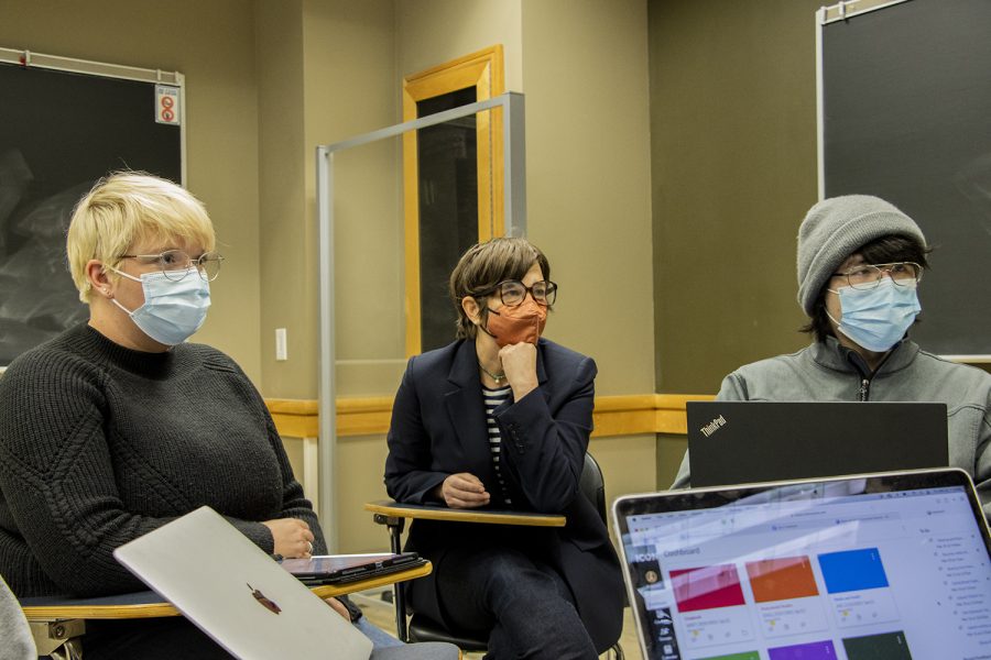 Rachel Young, an associate professor and director of undergraduate studies, works with a group of students in her class in the Adler Journalism building on Thursday, March 24, 2022.