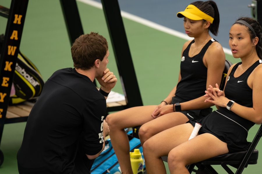 Iowa’s Michelle Bacalla and Samantha Gillas sit after losing their doubles match  during a women’s tennis meet between Iowa and Illinois at the Hawkeye Tennis & Recreation Complex on Friday, April 1, 2022.