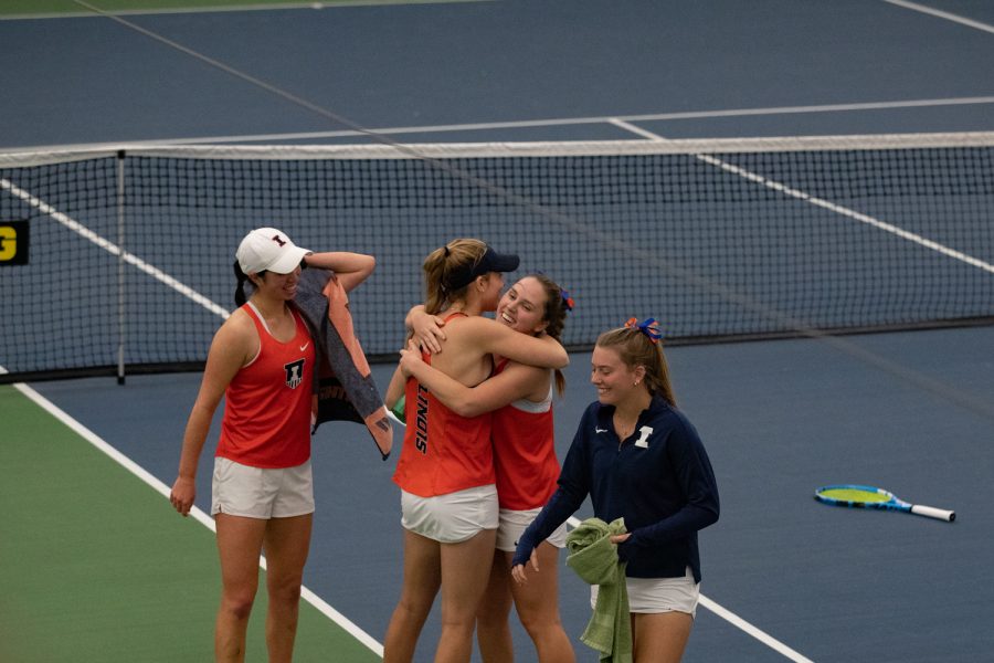 The Illinois women’s tennis team celebrates after their last won match during a women’s tennis meet between Iowa and Illinois inside the Hawkeyes Tennis & Recreation Complex on Friday, April 1, 2022. The Illini defeated the Hawkeyes, 4-2.