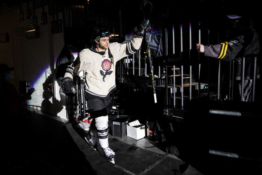 Iowa defenseman Riese Zmolek enters the ice after his name was announced in the starting lineup during a hockey match between Iowa and Wheeling at Xtream Arena in Coralville on Wednesday, April 6, 2022. The Nailers defeated the Heartlanders, 6-4. 