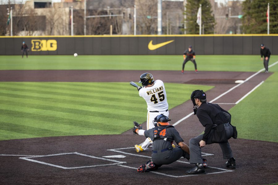 Iowa first baseman Peyton Williams hits the ball during the second baseball game of a doubleheader between Iowa and Illinois at Duane Banks Field in Iowa City on Saturday, April 9, 2022. Williams batted six times and scored one home run. The Fighting Illini defeated the Hawkeyes in 13 innings, 7-5.