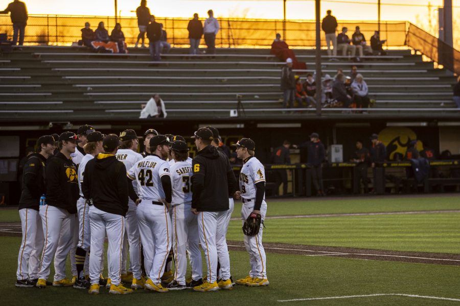 Iowa huddles up during the second baseball game of a doubleheader between Iowa and Illinois at Duane Banks Field in Iowa City on Saturday, April 9, 2022. Illinois and Iowa went into extra innings after a tie in the 9th inning. The Fighting Illini defeated the Hawkeyes in 13 innings, 7-5.