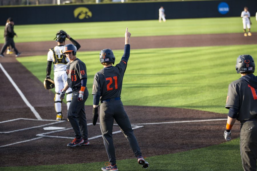 Illinois center fielder Danny Doligale celebrates a run during the second baseball game of a doubleheader between Iowa and Illinois at Duane Banks Field in Iowa City on Saturday, April 9, 2022. The Fighting Illini defeated the Hawkeyes in 13 innings, 7-5.