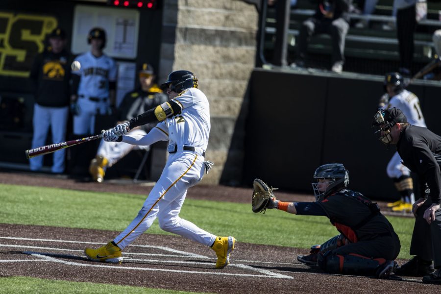 Iowa second baseman Brendan Sher hits the ball during the first baseball game of a doubleheader between Iowa and Illinois at Duane Banks Field in Iowa City on Saturday, April 9, 2022. Sher scored a home run in the 7th inning. The Hawkeyes defeated the Fighting Illini, 4-2.