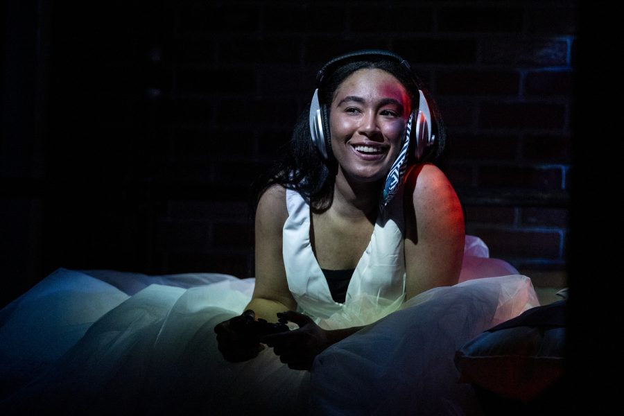 June, performed by Dajzané Meadows-Sanderlin, plays video games during a dress rehearsal for “BLKS” at the University of Iowa’s theatre building on Tuesday, April 12, 2022. The performance demonstrated what it’s like to be a Black queer woman.