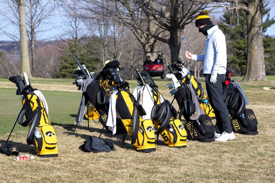 Iowa’s Ronan Kleu takes a golf club out of his bag during the 2022 men’s golf Hawkeye Invitational at Finkbine Golf Course on April 16, 2022.