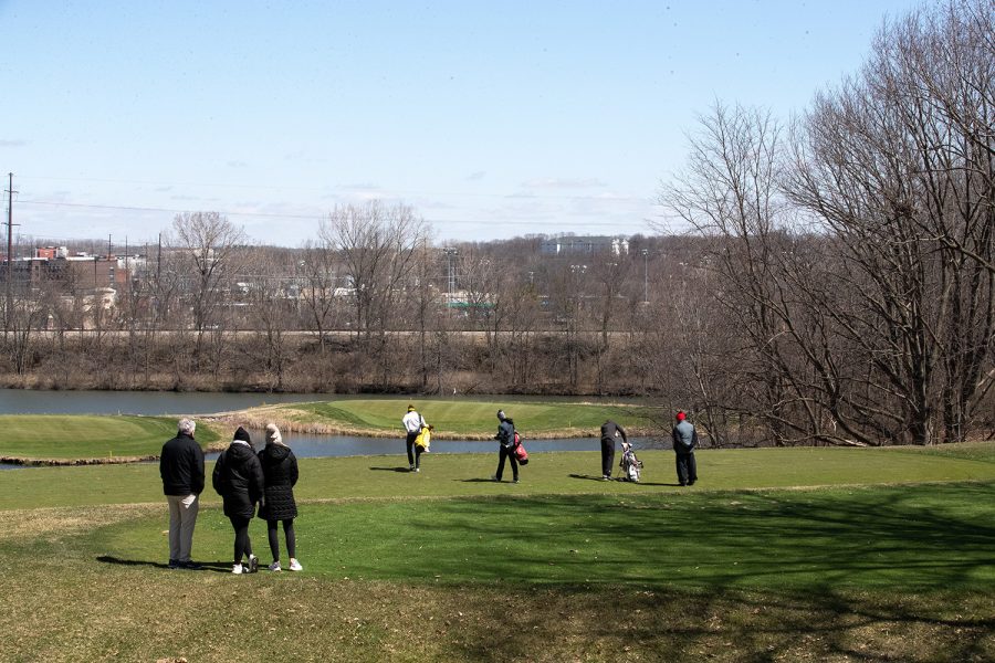 Golfers walk to hole 13 during the 2022 men’s golf Hawkeye Invitational at Finkbine Golf Course on April 16, 2022.