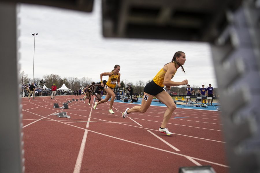Iowa women’s 200-meter dash runners Payton Wensel, left, and Erin Dowd, right, jump off the block during the Musco Twilight at Francis X. Cretzmeyer Track in Iowa City on Saturday, April 23, 2022. Wensel finished first with a time of 24.0 Dowd finished second overall with a time of 24.14. Iowa hosted its only outdoor meet this season.