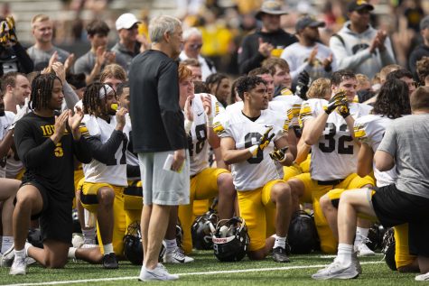 Iowa head coach Kirk Ferentz leads an applaud for a trainer during a spring practice at Kinnick Stadium on Saturday, April 23, 2022.