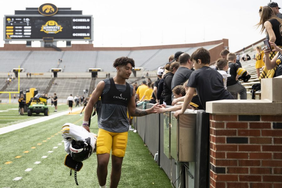 Iowa defensive back Xavier Nwankpa high fives fans after a spring practice at Kinnick Stadium on Saturday, April 23, 2022.