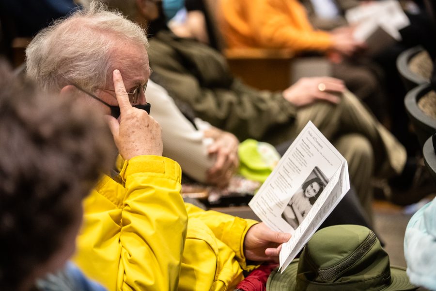 An attendee reads over a pamphlet before a planting ceremony for an Anne Frank sapling at MacBride Hall at the University of Iowa on Friday, April 29, 2022. The sapling was propagated from the chestnut tree behind the annex where Anne and family hid.