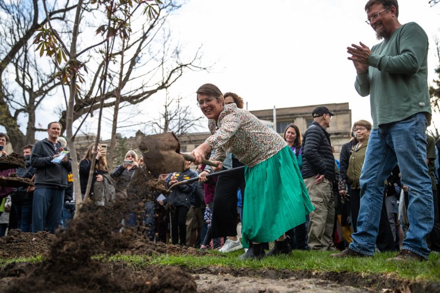 A community member shovels dirt onto the Anne Frank sapling at a planting ceremony on the Pentacrest at the University of Iowa on Friday, April 29, 2022. The sapling was propagated from the chestnut tree behind the annex where the Frank family hid.