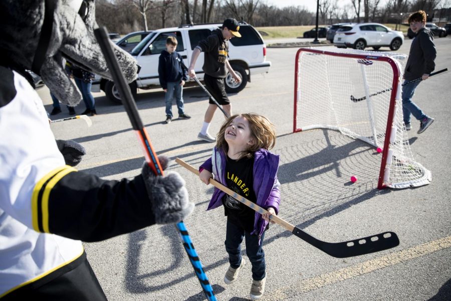 Charlie Kent greets Dash, the Heartlander’s mascot, during a tailgate before a hockey match between the Iowa Heartlanders and Indy Fuel at Xtream Arena in Coralville on Saturday, April 9, 2022. The tailgate celebrated the final home game of the Heartlander’s inaugural season.