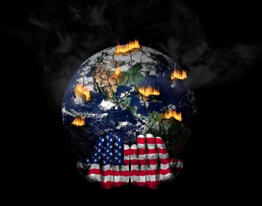 Hands painted with US flag holding stressed planet in crisis.