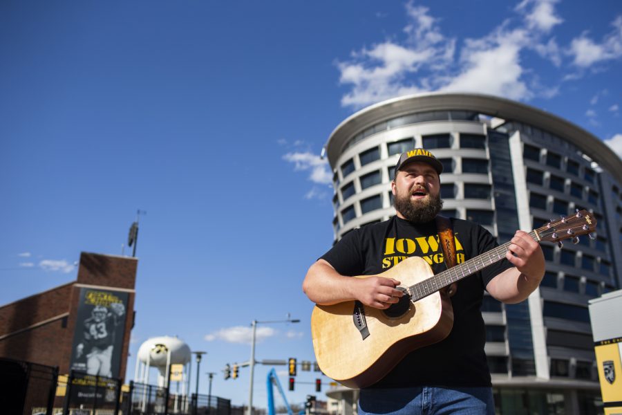 Dalles Jacobus, a former Iowa football player who graduated in 2020, performs his song ‘We Wave’ in front of the University of Iowa’s Stead Family Childrens Hospital on Sunday, April 24, 2022. Jacobus is pushing ‘We Wave’ to become the new song playing during Iowa’s wave to the children’s hospital at the end of the first quarter.