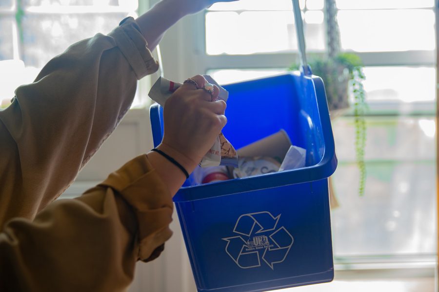 Photo illustration of an individual recycling.