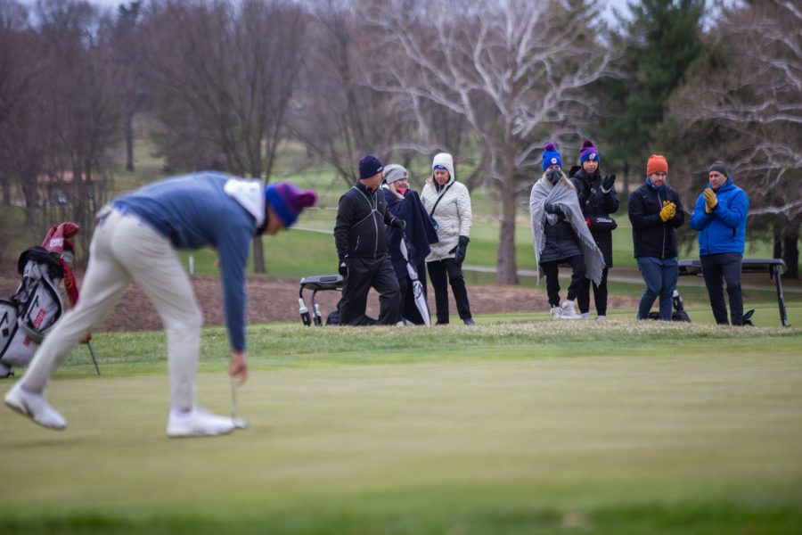 Kansas fans clap as Kansas golfer Ben Sigel reaches for a ball during day two of the Hawkeye Invitational at Finkbine Golf Course in Iowa City on April 17, 2022. Sigel finished in 3rd with a score of 210.