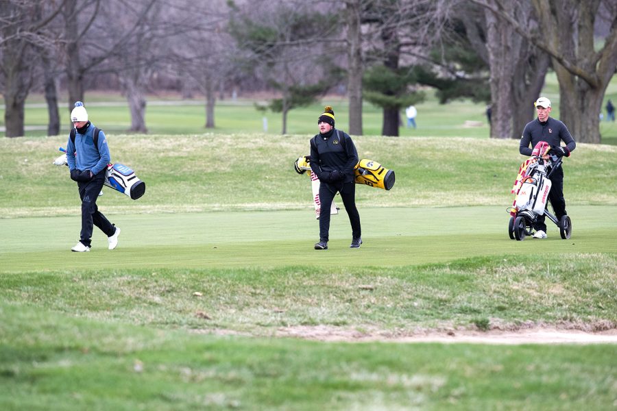 Kansas’ Harry Hillier, Iowa’s Garrett Tighe and Minnesota’s Ben Warian walk up the course during day two of the Hawkeye invitational at Finkbine Golf Course in Iowa City on April 17, 2022.