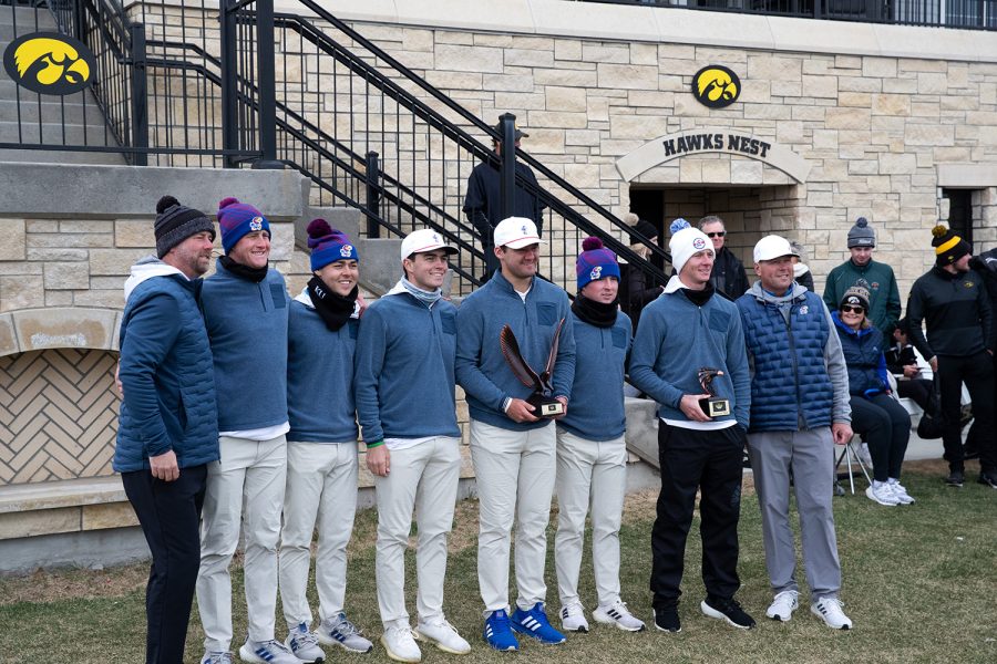 The Kansa men’s golf team poses with the first place trophy during day two of the Hawkeye invitational at Finkbine Golf Course in Iowa City on April 17, 2022. The Jayhawks placed first overall in the invitational with a total team score of 852.