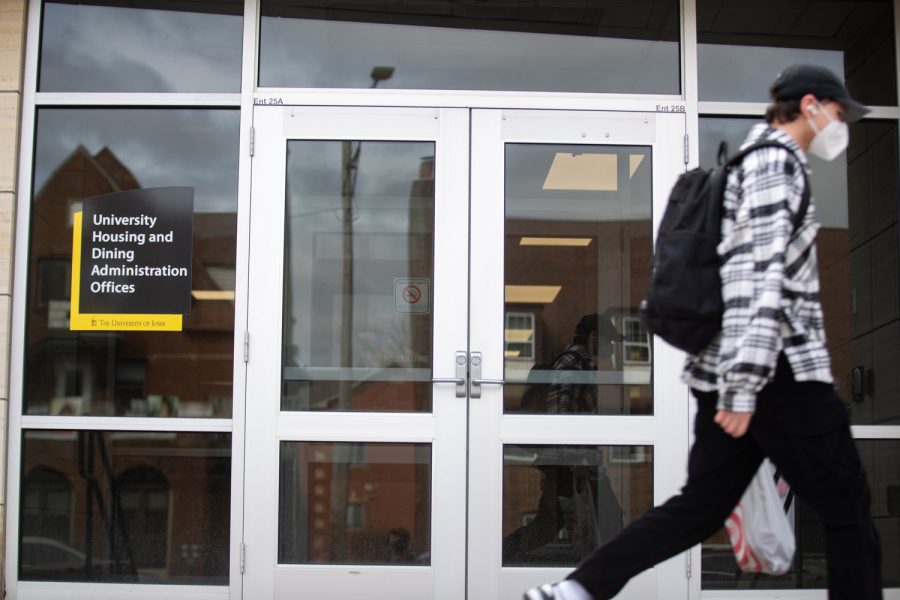 A student walks past the University Housing and Dining Administration Offices in Iowa City on Monday, April 4, 2022. 