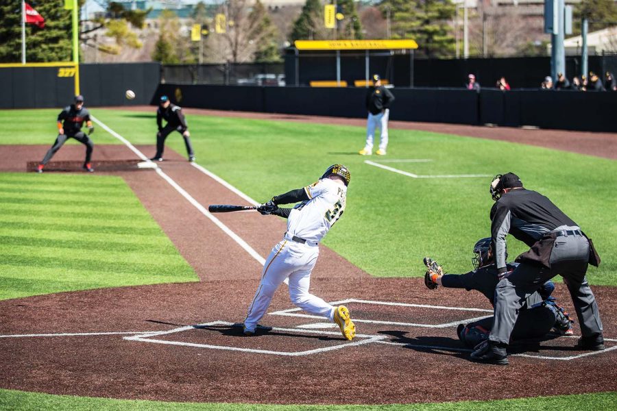 Iowa’s left fielder Sam Petersen hits the ball during the first baseball game of a doubleheader between Iowa and Illinois at Duane Banks Field in Iowa City on Saturday, April 9, 2022. Petersen batted four times. The Hawkeyes defeated the Fighting Illini, 4-2.