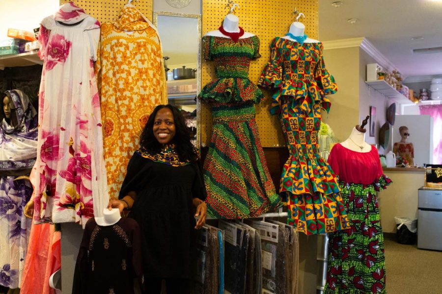 Naa + Adjeiwa + Tackie% 2C + the + owner + of + Nanas + African + Boutique% 2C + is + next + to + clothes + from + North + Africa + and + West + Africa + in + her + shop + in + Iowa + City + on + Thursday% 2C + April + 7% 2C + 2022. + Tackie + stocked + clothing + from + his + store + for + Walk + It + Out.