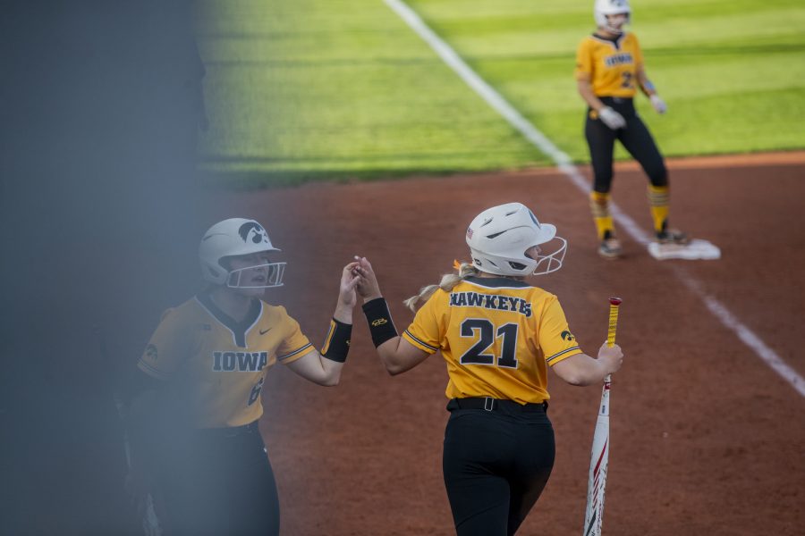 Iowa outfielder Zoey Schulte and outfielder Rylie Moss high five after Schulte made it home during a softball game between Iowa and Purdue at Pearl Field in Iowa City on Friday, May 6, 2022. Schulte had one run. The Boilermakers defeated the Hawkeyes, 5-1.