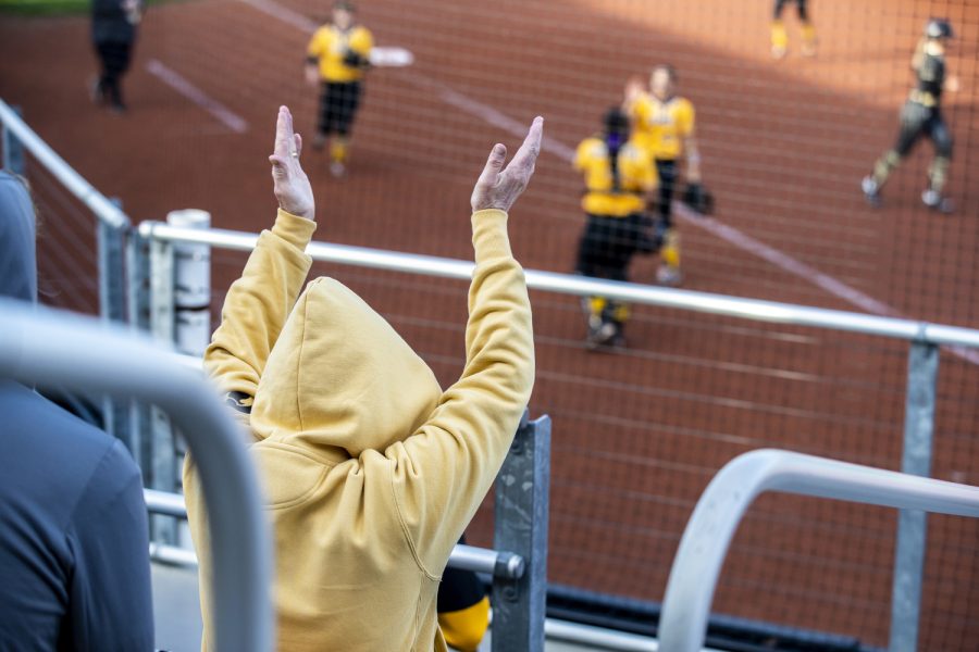 A fan claps during a softball game between Iowa and Purdue at Pearl Field in Iowa City on Friday, May 6, 2022. The Boilermakers defeated the Hawkeyes, 5-1.