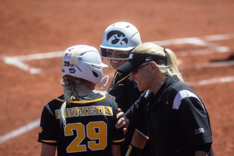 Iowa head coach Renee GIllispie talks with Iowa players during a softball game between Iowa and Purdue at Bob Pearl Field in Iowa City on Saturday, May 7, 2022. The Hawkeyes beat the Boilermakers, 9-3.