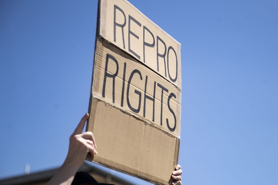 An attendee holds up a sign during a march for abortion rights in Iowa City on Saturday, May 7, 2022.