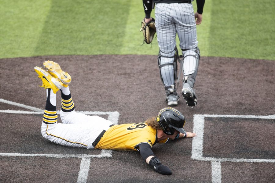 Iowa left fielder Ben Wilmes slides across home plate during a baseball game between Iowa and Purdue at Duane Banks Field in Iowa City on Sunday, May 8, 2022. Iowa scored five of their nine runs in the fifth inning. The Hawkeyes defeated the Boilermakers, 9-1.