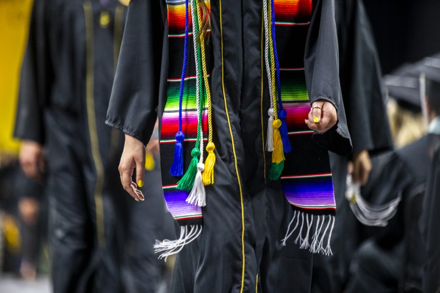 A+graduate+walks+down+the+aisle+during+the+University+of+Iowas+Commencement+Ceremony+for+College+of+Liberal+Arts+and+Sciences+spring+2022+graduates+at+Carver-Hawkeye+Arena+on+Saturday%2C+May+14%2C+2022.