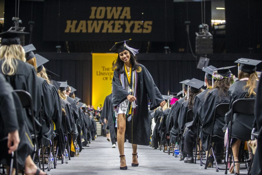 A graduate celebrates during the University of Iowa’s Commencement Ceremony for College of Liberal Arts and Sciences spring 2022 graduates at Carver-Hawkeye Arena on Saturday, May 14, 2022.
