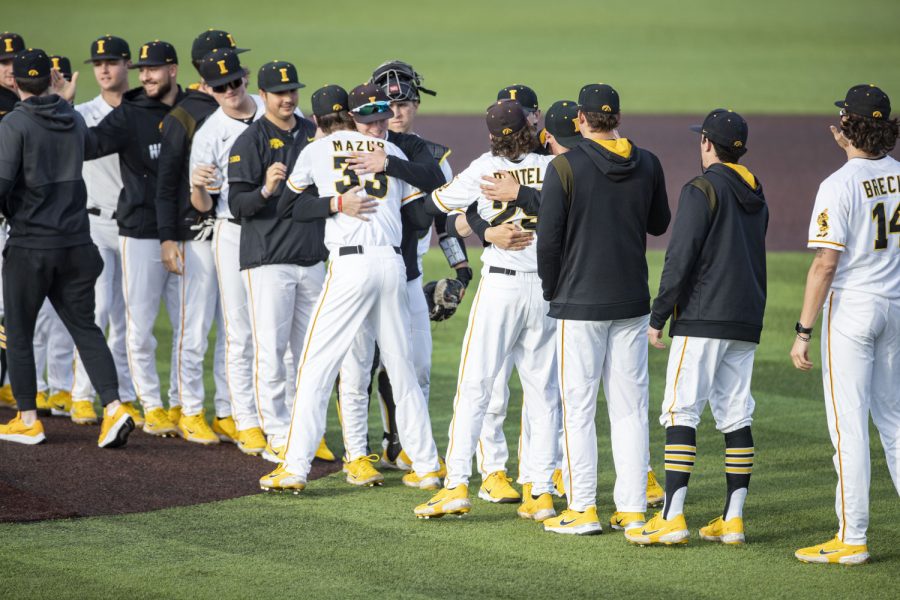 Members of the Iowa baseball team hug pitchers Adam Mazur and Ben Beutel after pitching during a baseball game between Iowa and Purdue at Duane Banks Field in Iowa City on Friday, May 6, 2022. Mazur and Beutel had a combined pitch count of 100. The Hawkeyes defeated the Boilermakers 5-2.