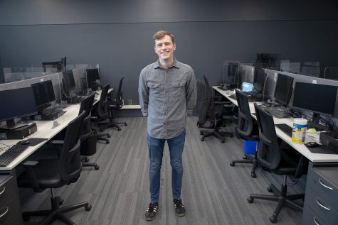 University of Iowa student Ben Stone poses for a portrait inside of a research center in the Belin Blank Honors Center on May 5, 2022.