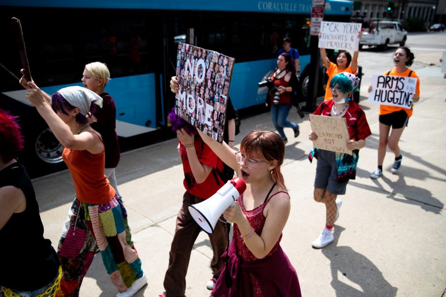 Protestors chant while marching from College Green Park to the University of Iowa Pentacrest during a protest against gun violence on Monday, June 13, 2022. Around 20 people attended the demonstration.