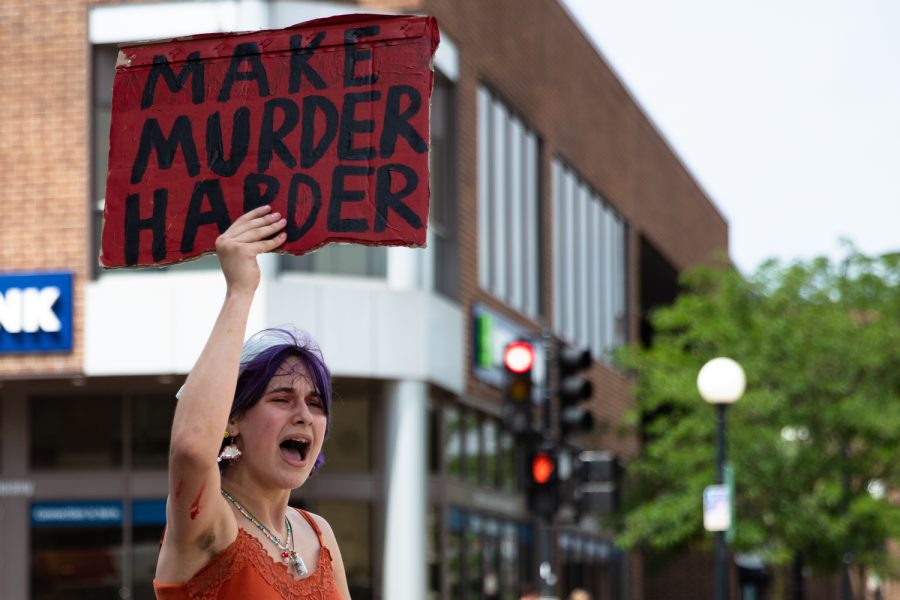 A protestor chants while marching from College Green Park to the University of Iowa Pentacrest during a protest against gun violence on Monday, June 13, 2022. Around 20 people attended the demonstration.