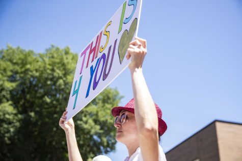 A parade participant walks with a sign saying “This is 4 you” during the Iowa City Pride Parade in Iowa City on Saturday, June 18, 2022. The Revaux family’s close friends, Lauren Magnani, 39, and Tomeka Magnani, 32, who have a daughter Addie’s age, also emphasized how important the exposure of the LGBTQ community is for young children. When Lauren was younger, she did not get to see different types of families or people. “Its just really good because then [children] feel like theyre just as valid as any other person or family,” she said.