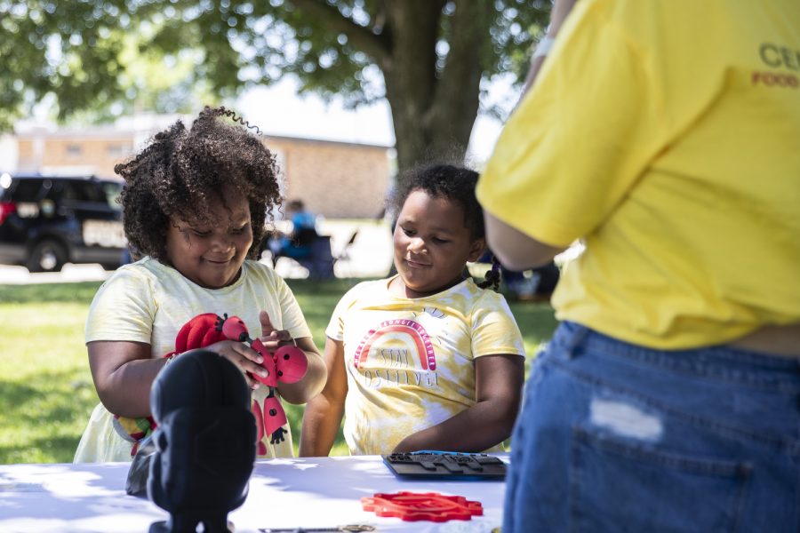 Jaunita, left, and Elizabeth Thomas, right, check out a stand during ‘Juneteenth in our Neighborhood’ for a Juneteenth celebration in Iowa City on Saturday, June 18, 2022. Iowa City community members celebrated with music, games, vendors, and a fashion show.