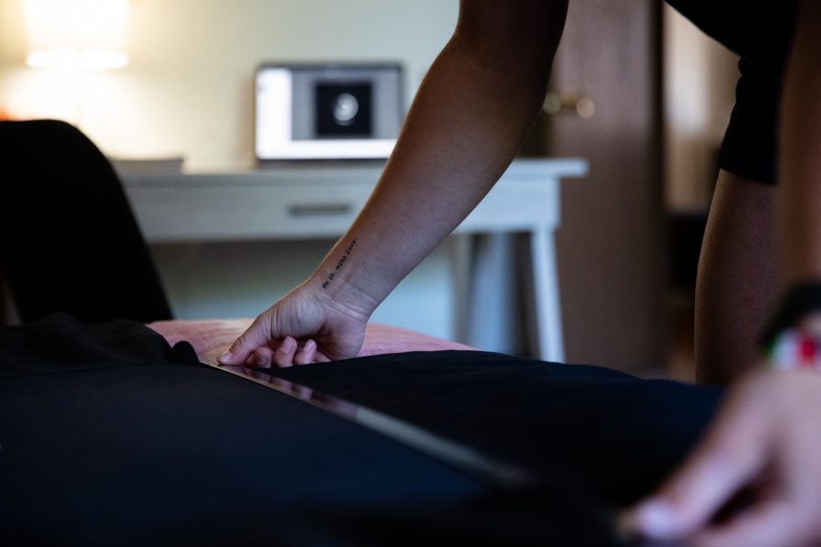 Iowa rower Jaecee Hall lines up the ruler onto a shirt at her apartment in Iowa City on Sunday, June 19, 2022.