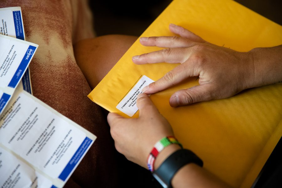 Iowa rower Jaecee Hall applies a label onto a package at her apartment in Iowa City on Sunday, June 19, 2022.